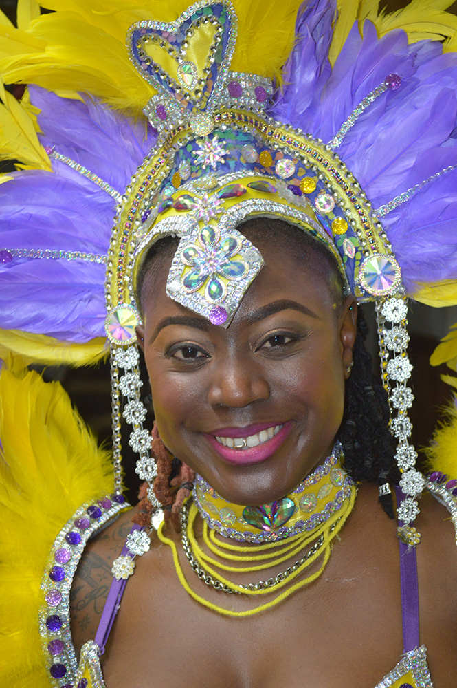 Bahamas Carnival masquerader in a bright feathered costume.